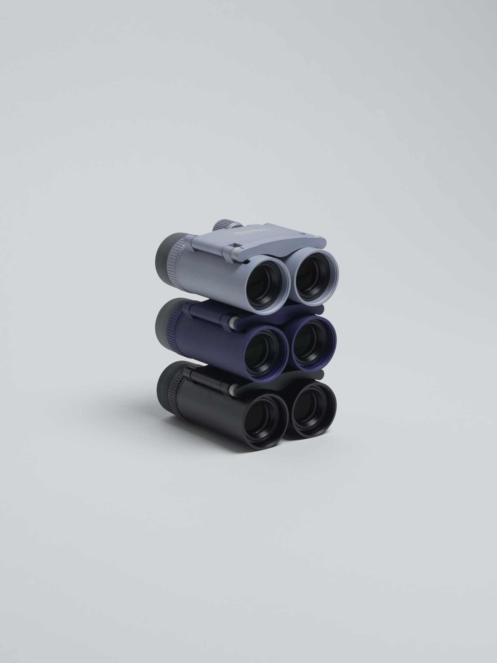 Hand cradling a Double Lion marine binocular