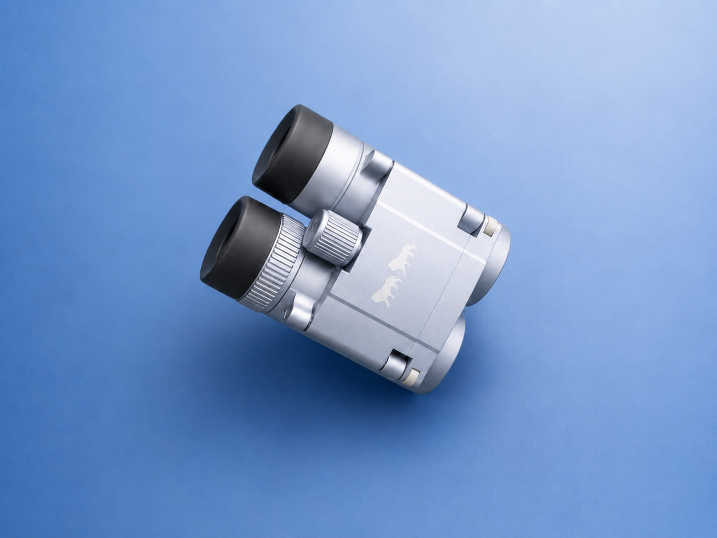 Silver binocular eyepieces on blue